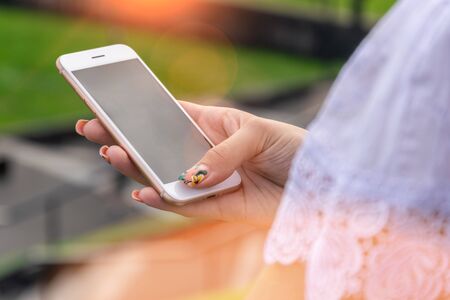 Woman texting on smart phone on during sunset. Travel conceptの写真素材