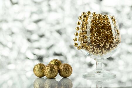 Christmas balls, wine glass, christmas decorations on silver abstract background. Christmas composition.の写真素材