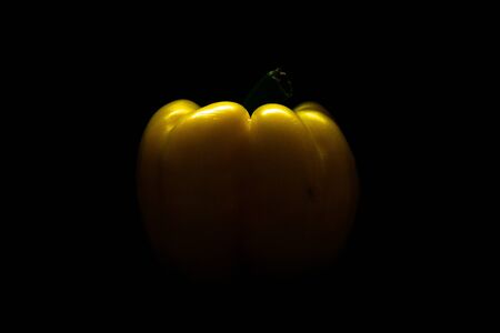 Fresh yellow capsicum paprika isolated on black. Healthy eating concept. Bell pepper isolated on black.の写真素材