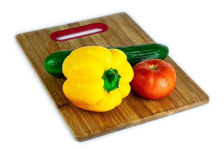 Fresh paprika, cucumber, tomato isolated on wooden blackboard. Organic vegetables. Healthy eating concept.の写真素材
