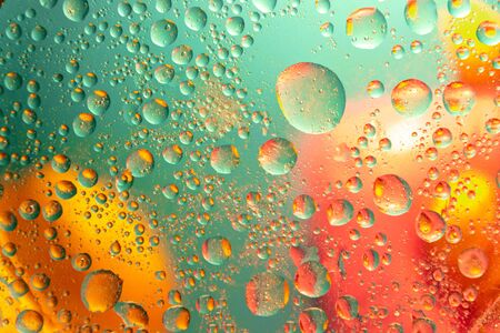 Abstract pattern of colored oil bubbles on water. Oil drops in water abstract psychedelic pattern image.の写真素材