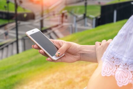 Woman texting on smart phone on during sunset. Travel conceptの写真素材