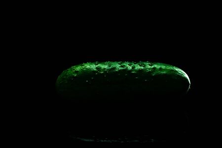 Raw, fresh, green cucumber isolated on black background for salad. Healthy eating concept.の写真素材