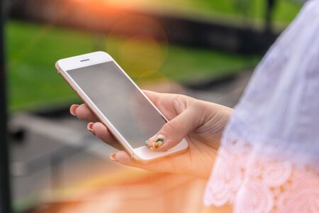 Woman texting on smart phone on during sunset. Travel conceptの写真素材