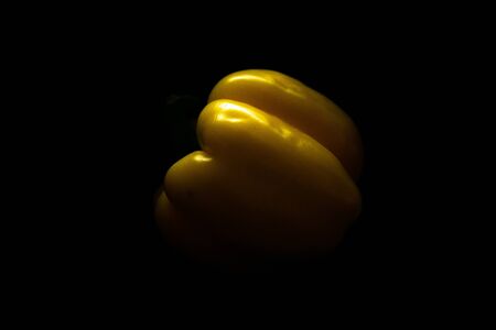 Fresh yellow capsicum paprika isolated on black. Healthy eating concept. Bell pepper isolated on black.の写真素材
