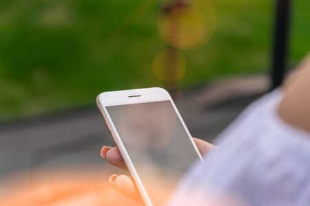 Woman texting on smart phone on during sunset. Travel conceptの写真素材