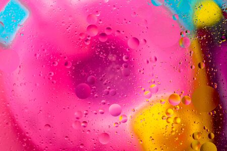 Abstract pattern of colored oil bubbles on water. Oil drops in water abstract psychedelic pattern image.の写真素材