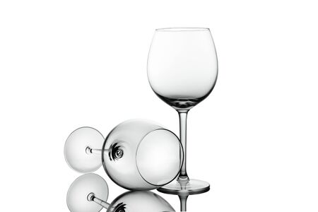 Clean Empty wine glasses with reflections on white background. Alcohol beverage card backdrop.の写真素材
