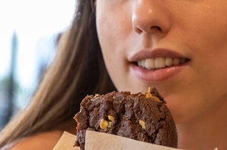 Young beautiful woman eating a dessert. Breakfast time.の写真素材