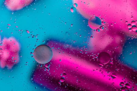 Abstract pattern of colored oil bubbles on water. Oil drops in water abstract psychedelic pattern image.の写真素材