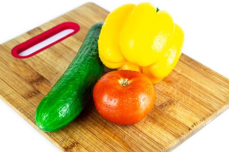 Fresh paprika, cucumber, tomato isolated on wooden blackboard. Organic vegetables. Healthy eating concept. With  .の写真素材