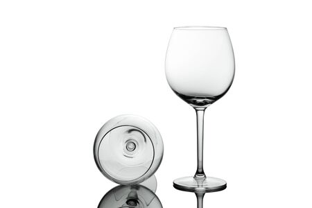 Empty elegant Crystal wine glasses with wine isolated on white background. Alcohol beverage card backdrop.の写真素材