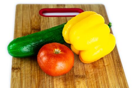 Fresh paprika, cucumber, tomato isolated on wooden blackboard. Organic vegetables. Healthy eating concept. With  .の写真素材