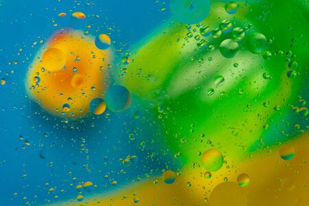 Abstract pattern of colored oil bubbles on water. Oil drops in water abstract psychedelic pattern image.の写真素材
