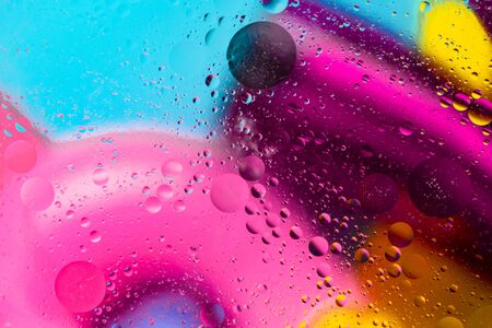 Abstract pattern of colored oil bubbles on water. Oil drops in water abstract psychedelic pattern image.の写真素材