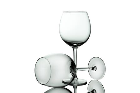 Clean Empty wine glasses with reflections on white background. Alcohol beverage card backdrop.の写真素材