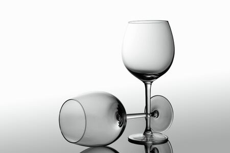 Empty elegant Crystal wine glasses with wine isolated on white background. Alcohol beverage card backdrop.の写真素材
