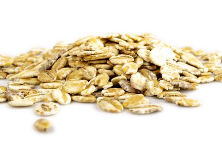 Oat flakes, pile of oatmeal - Organic ingredients for healthy breakfast.の写真素材