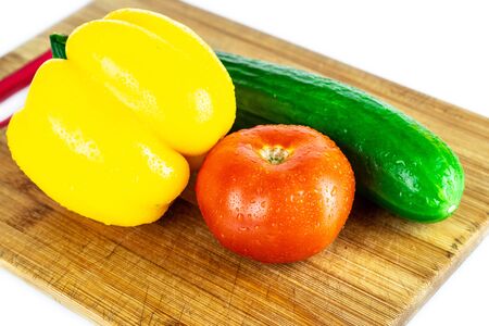 Fresh paprika, cucumber, tomato isolated on wooden blackboard. Organic vegetables. Healthy eating concept.の写真素材