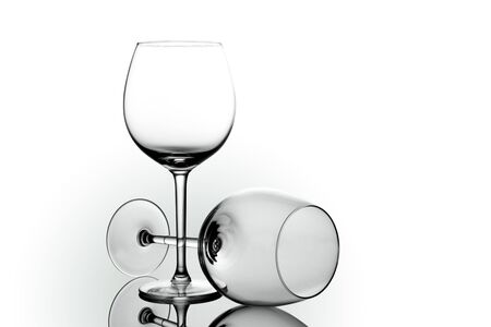 Empty elegant Crystal wine glasses with wine isolated on white background. Alcohol beverage card backdrop.の写真素材