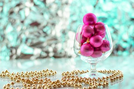 Christmas balls, wine glass, christmas decorations on silver abstract background. Christmas composition.の写真素材