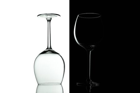 Clean Empty wine glasses with reflections on black and white background. Alcohol beverage card backdrop.の写真素材