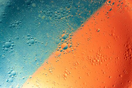 Colorful abstract background. Water drops on glass. Amazing abstract water drops on glass texture or background.  Blue and orange abstract backgroundの写真素材