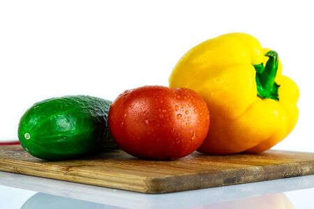 Fresh paprika, cucumber, tomato isolated on wooden blackboard. Organic vegetables. Healthy eating concept.の写真素材