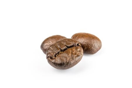 Three shiny fresh roasted coffee beans isolated on white background. Coffee background or texture concept.の写真素材