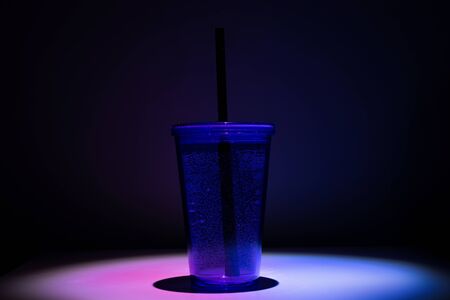 Plastic cup. Bottle for drink water with black straw.の写真素材