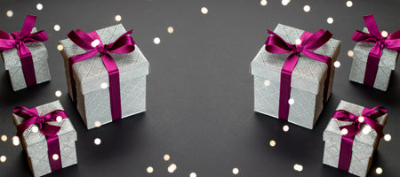 Xmas background. Red Christmas gifts, ornaments on dark backgrou