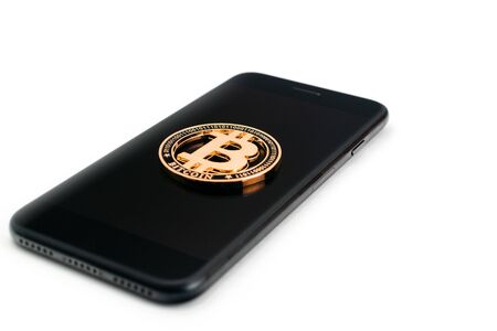 Bitcoin business. Gold coin black phone on white. Litecoin, Ethereum Cryptocurrency background.の写真素材