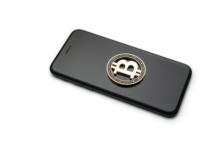 Cryptocurrency background. Gold Bitcoin with phone isolated on white. Money concept