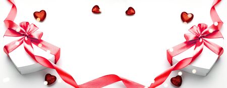 Valentines day card. Heart shaped gift box with red ribbon isolated on white. Romantic message template with copy space.の写真素材