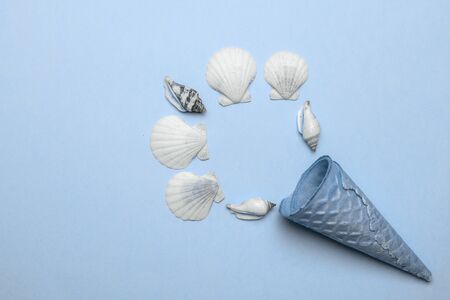 Summer sale. White seashells, starfish in shape frame isolated on trendy aquamarine light blue pastel color background. Hello Summer is coming conceptの写真素材