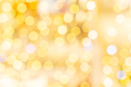 White gold abstract lights. Festive glitter blur Bokeh background. Defocused winter backdropの写真素材