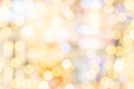 Bokeh fashion. Gold glitter abstract lights. Festive blur background. Soft yellow christmas...