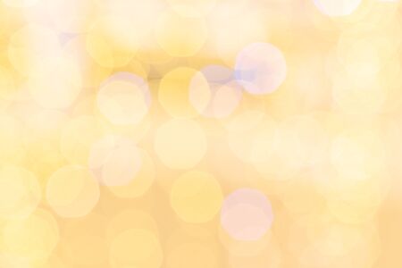 Gold bokeh lights. Abstract glitter festive blur background. Christmas and New Year holidays backdropの写真素材