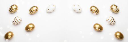 Easter egg hunt. Easter composition: golden shine decorated eggs in basket. Greeting card trendy design. for you poster or flyerの写真素材