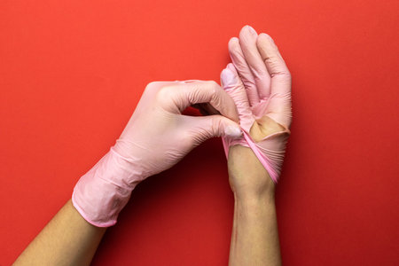 Antibacterial hand Using lab gloves on Medical red background. Cleansing hand hygiene for...