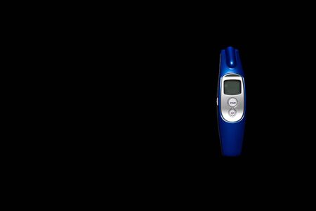 Medical equipment background. Protective Electronic modern thermometer on black background. Coronavirus disease.の写真素材