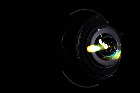 Lenses reflection Flare lights on shutter of photo, video camera isolated on black background. Optical ray flash effect in photographer equipment.の写真素材