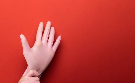 Antibacterial hand Using lab gloves on Medical red background. Cleansing hand hygiene for coronavirus outbreak prevention. Preventive Measures concept. Professional safety and hygieneの写真素材
