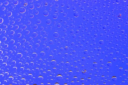 Drops background. Wet water on glass. Rain pattern textureの写真素材