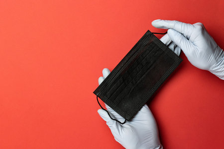 Health glove, face mask on medical red background. Antibacterial lab gloves, respirator bandage. Virus protection Preventive Measures. Novel Coronavirus 2019-nCoV. Professional safety, hygieneの写真素材