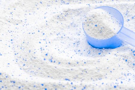 Cleansing products. Soap white texture with scoop. Liquid powder detergent in cup for washing machine. Laundry wash clothes background. Eco style cleaning concept.の写真素材