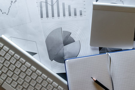 Reviewing paperwork. Charts graphs diagrams on table. Analytics finance background. Concept image of...