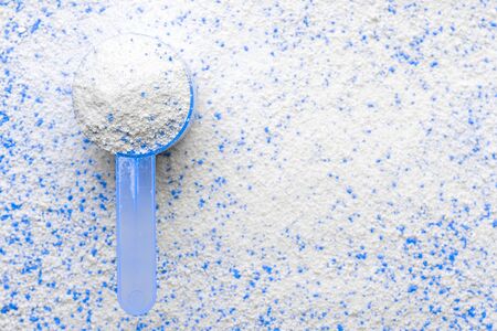 Clean detergent. White wash powder texture in cup or scoop for washing machine. Liquid soap laundry background. Eco style cleaning conceptの写真素材