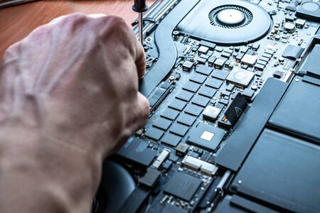 Computer motherboard electronic repair. Hardware service technology from technician engineer man. Maintenance pc equipment.の写真素材
