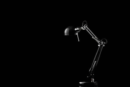 Table light furniture decor. Modern home lamp on office desk isolated on black background.の写真素材